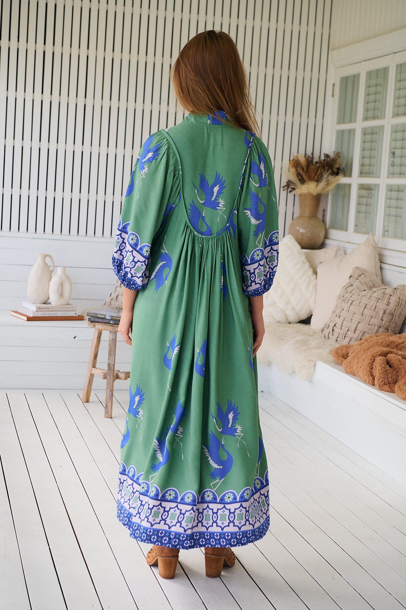 Model wearing Bluebird Boheme Midi Dress by Jaase - boho floral print, long sleeves, soft rayon fabric, relaxed flowy silhouette.