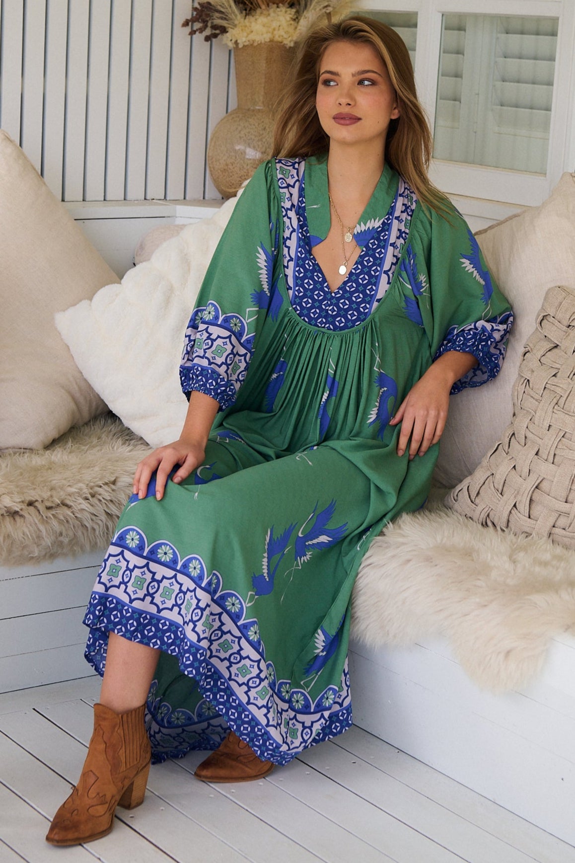 Model wearing Bluebird Boheme Midi Dress by Jaase - boho floral print, long sleeves, soft rayon fabric, relaxed flowy silhouette.