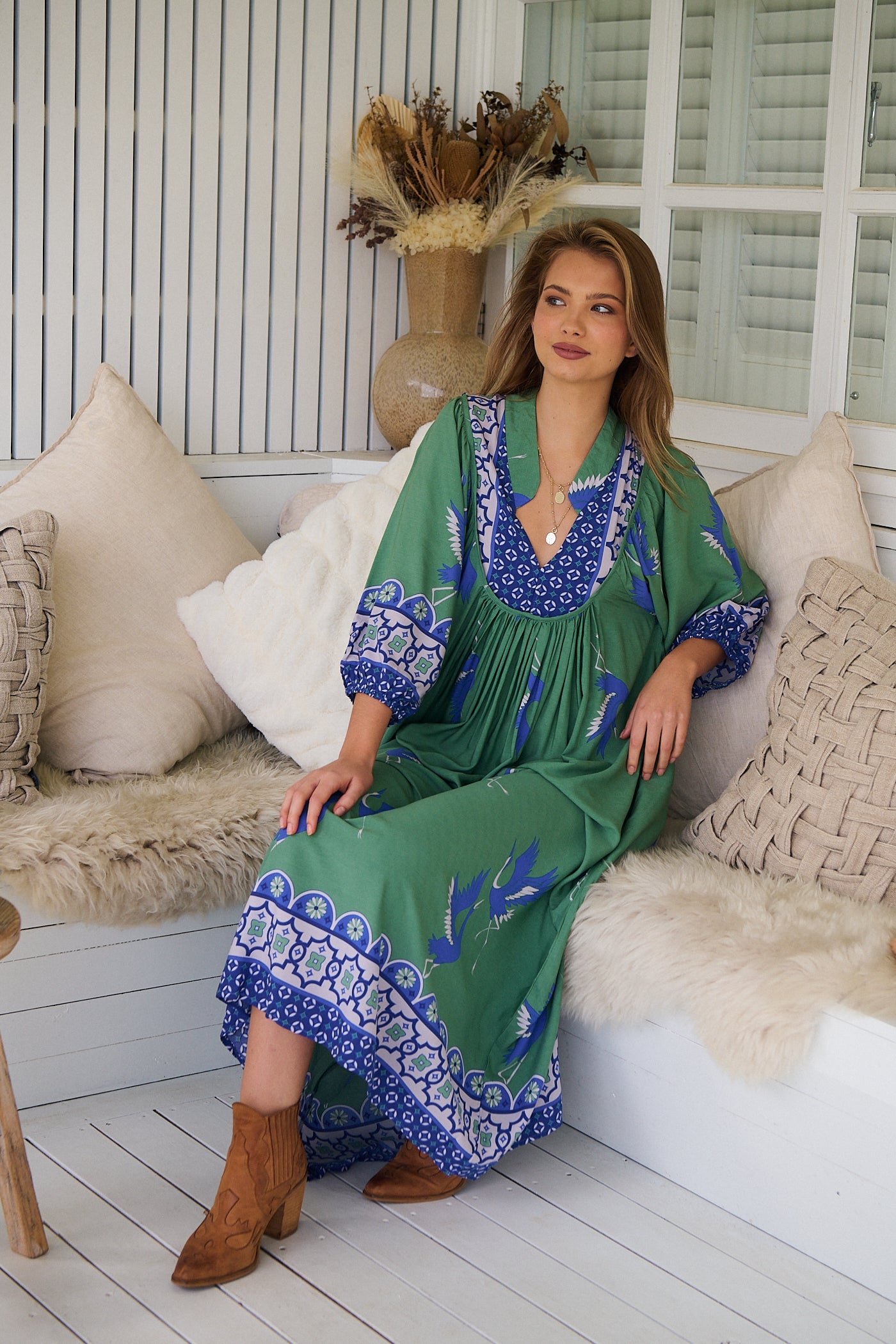 Model wearing Bluebird Boheme Midi Dress by Jaase - boho floral print, long sleeves, soft rayon fabric, relaxed flowy silhouette.