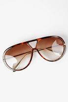 Woman wearing Jacqueline oversized aviator sunglasses in brown tortoiseshell with gradient lenses
