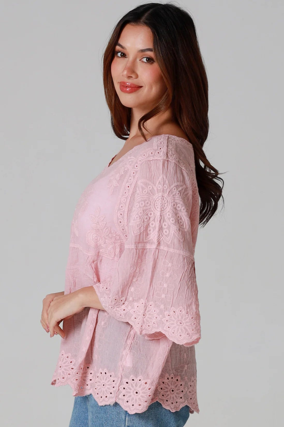 Woman wearing pink embroidered cotton boho blouse with scalloped hem - Marabel Boho Tops Australia.