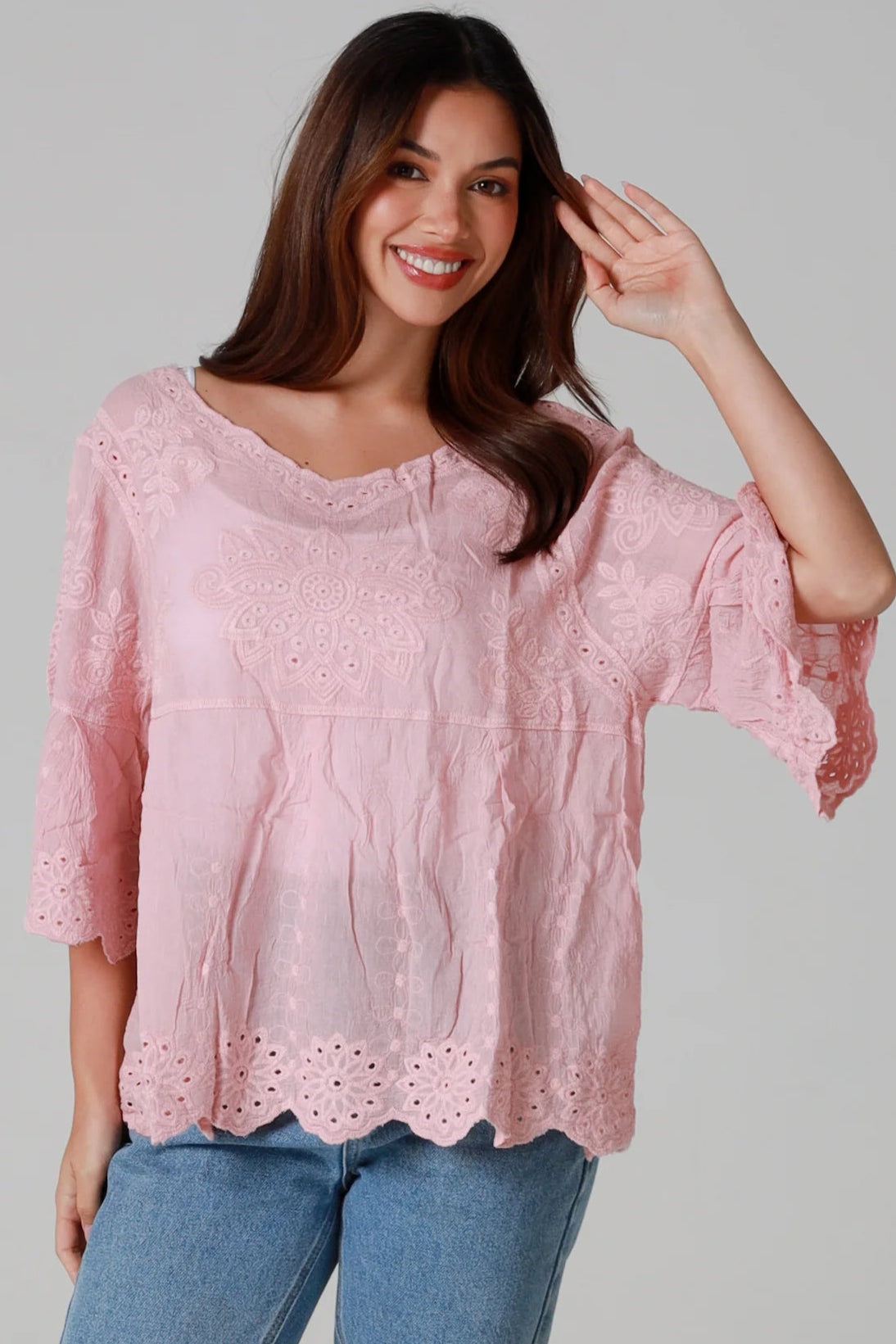 Woman wearing pink embroidered cotton boho blouse with scalloped hem - Marabel Boho Tops Australia.