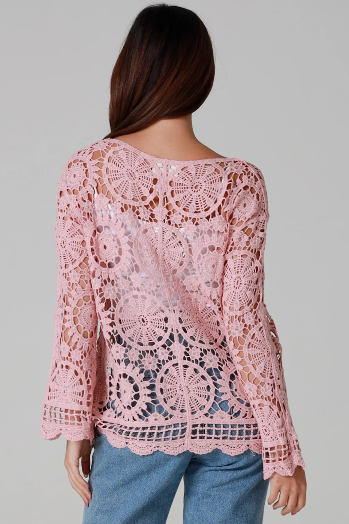 Women in blush pink cotton crochet cardigan with tie front and scalloped hem - boho chic cardigan Australia.