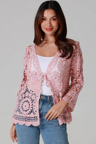 Women in blush pink cotton crochet cardigan with tie front and scalloped hem - boho chic cardigan Australia.