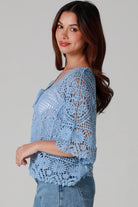 “Sky blue bohemian crochet cotton cardigan with scalloped sleeves and floral tie detail – boho knitwear Australia.”