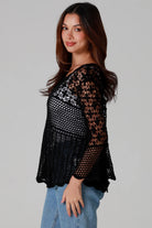 woman wearing black cotton crochet top with scalloped sleeves and flared hem - Boho crochet blouse Australia.