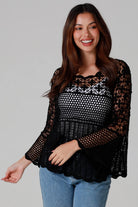 woman wearing black cotton crochet top with scalloped sleeves and flared hem - Boho crochet blouse Australia.