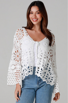 White crochet cardigan with tie front and boho bell sleeves layered over denim - crochet cardigan Australia.