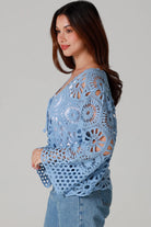 Pale blue cotton crochet boho cardigan with bell sleeves and tie front styled with denim - bohemian coastal fashion.