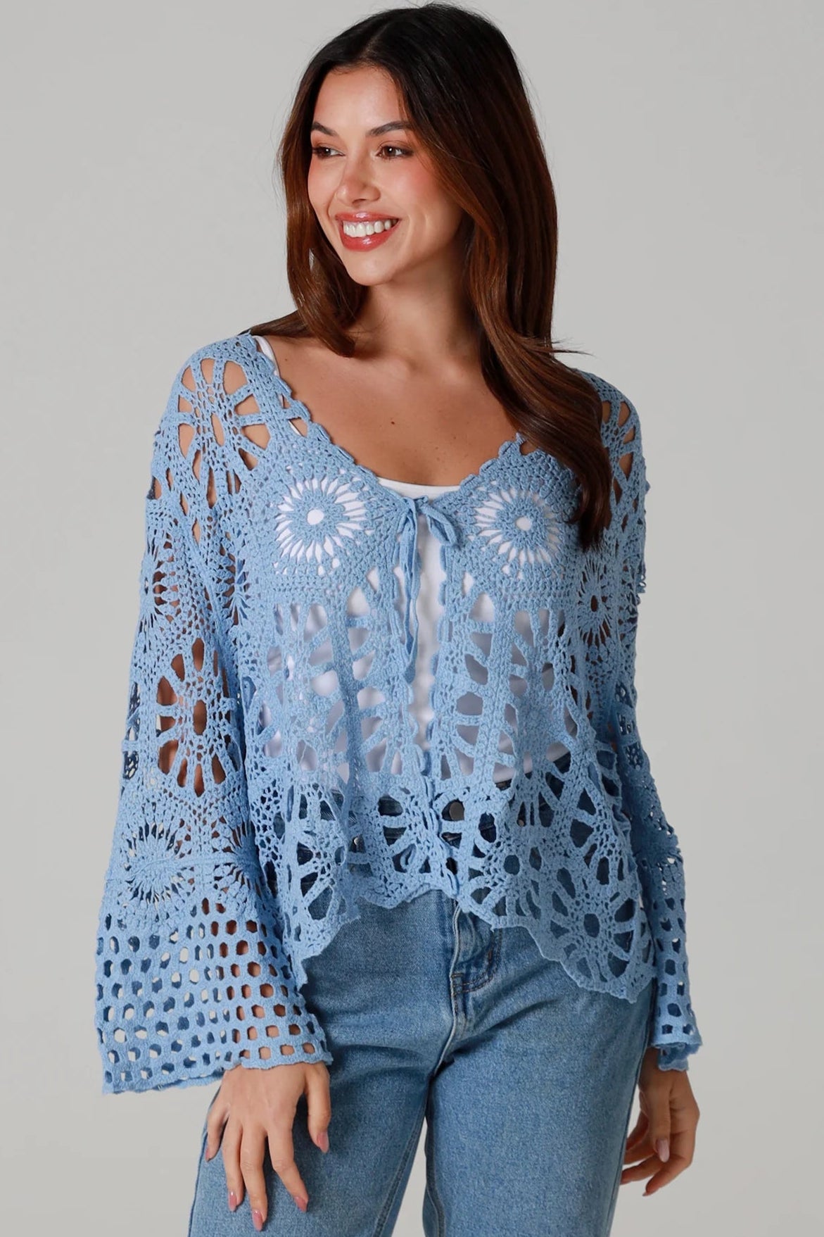Pale blue cotton crochet boho cardigan with bell sleeves and tie front styled with denim - bohemian coastal fashion.