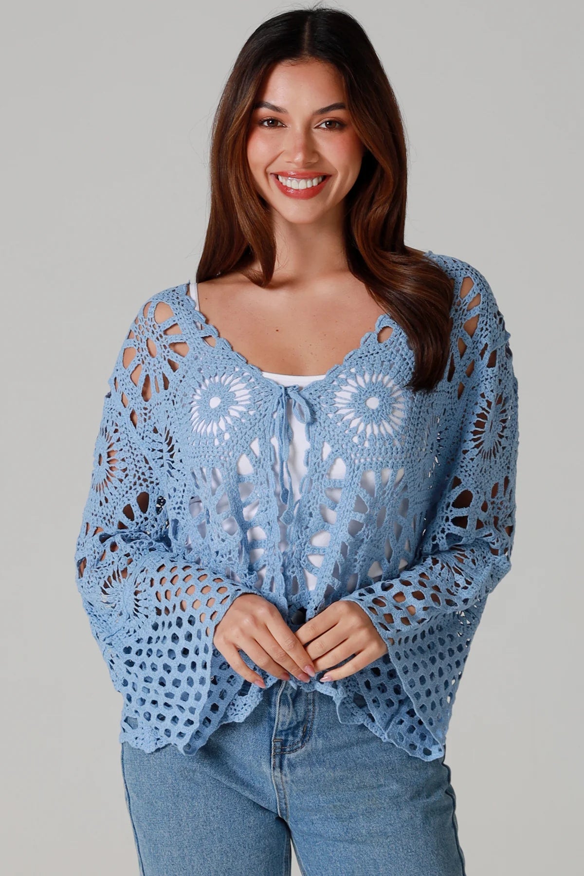 Pale blue cotton crochet boho cardigan with bell sleeves and tie front styled with denim - bohemian coastal fashion.