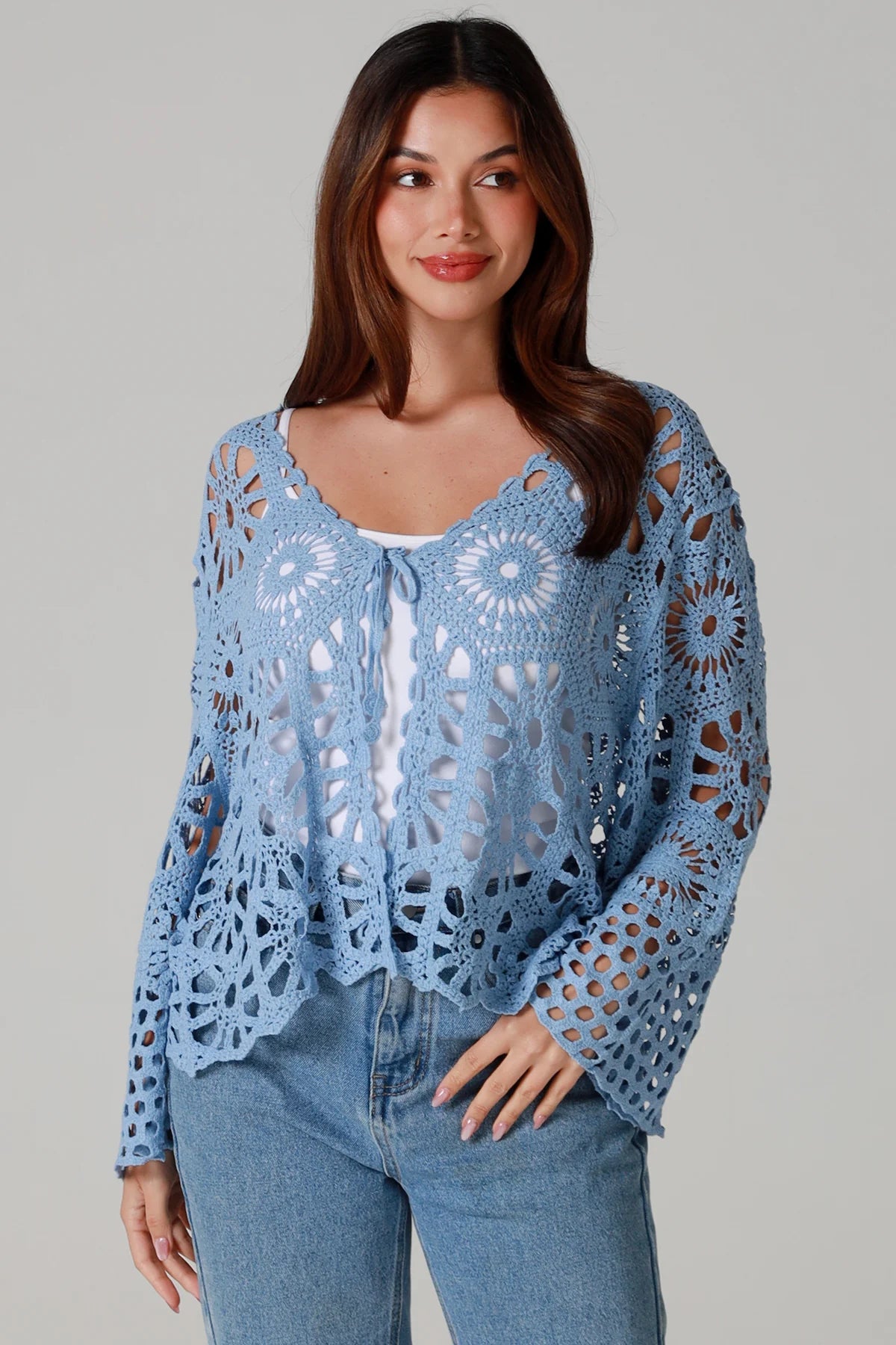 Pale blue cotton crochet boho cardigan with bell sleeves and tie front styled with denim - bohemian coastal fashion.