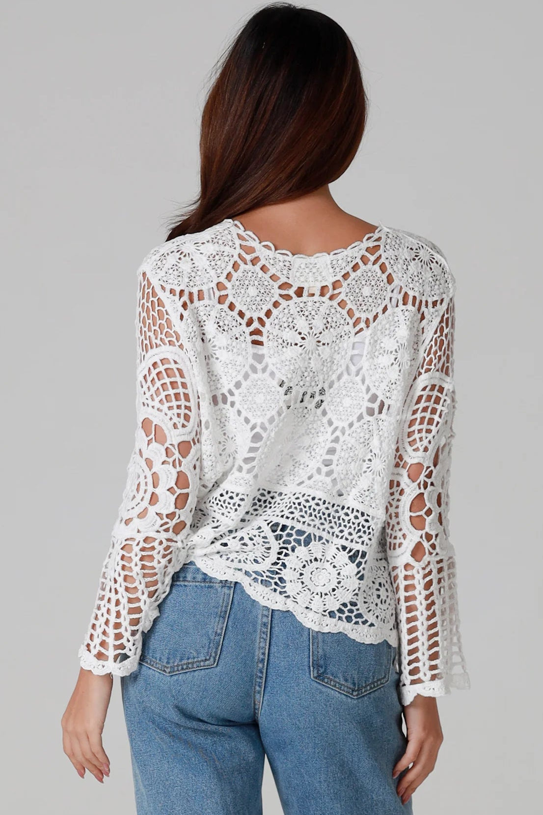 Woman in white cotton crochet embroidered top with flared sleeves and tie-front – Australian boho style