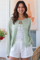 Woman wearing sage cotton crochet cardigan – textured boho statement layer by Bohemian Love Runway