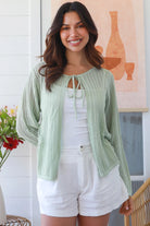 Woman wearing sage cotton crochet cardigan – textured boho statement layer by Bohemian Love Runway
