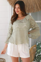 Model wearing sage green cotton crochet top with honeycomb lace and flared sleeves - Willow crochet Top Australia