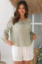 Model wearing sage green cotton crochet top with honeycomb lace and flared sleeves - Willow crochet Top Australia