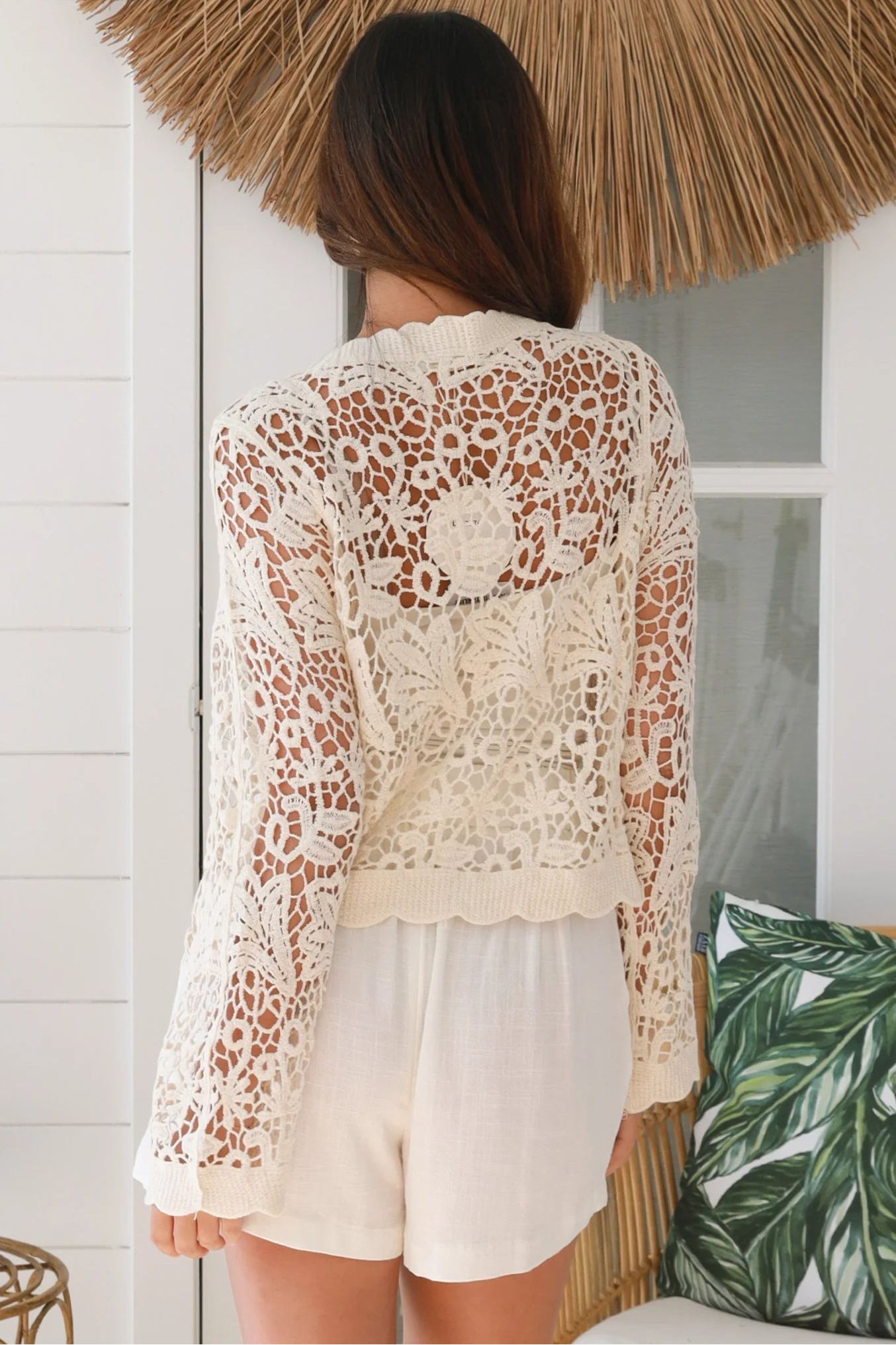 Bohemian woman in cream crochet cotton jacket with scalloped lace edges and button front - versatile boho jacket Australia
