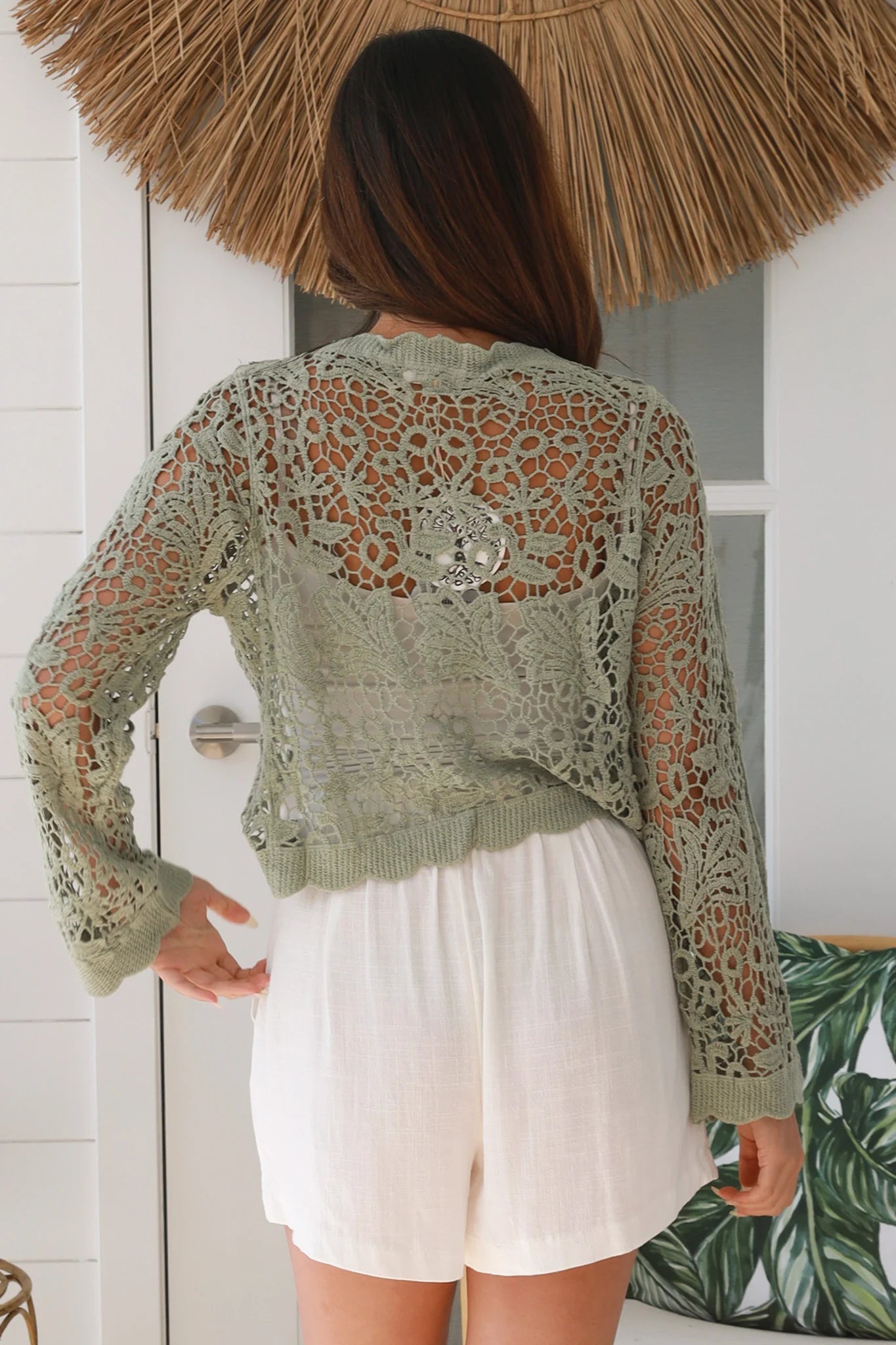 Woman in sage green crochet cotton jacket with scalloped edges and button front- bohemian fashion Australia