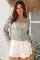 Woman in sage green crochet cotton jacket with scalloped edges and button front- bohemian fashion Australia