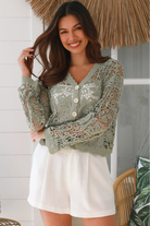 Woman in sage green crochet cotton jacket with scalloped edges and button front- bohemian fashion Australia