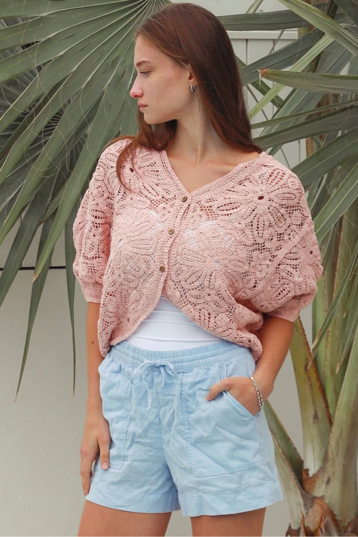 Pink embroidered cotton lace cardigan with V-neckline, button-through front and softly rounded hem