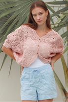 Pink embroidered cotton lace cardigan with V-neckline, button-through front and softly rounded hem