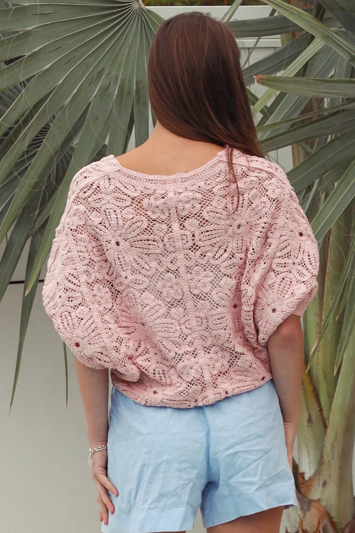 Pink embroidered cotton lace cardigan with V-neckline, button-through front and softly rounded hem