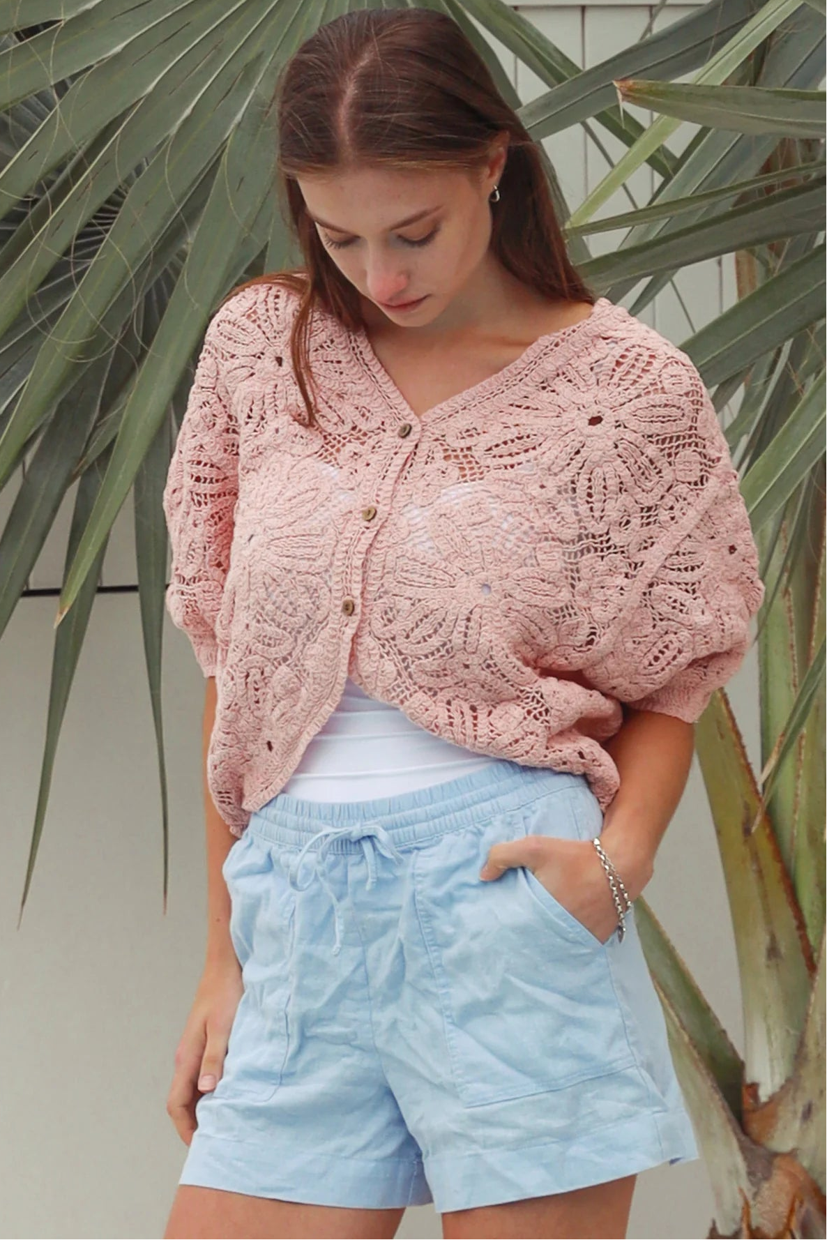 Pink embroidered cotton lace cardigan with V-neckline, button-through front and softly rounded hem