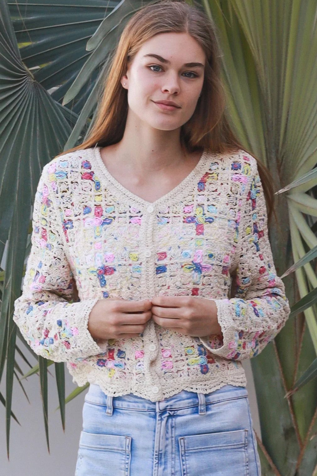 Woman wearing pastel embroidered cotton boho cardigan with textured crochet weave and relaxed vintage - inspired styling in Australia.