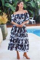 Black ikat boho midi dress worn on or off shoulder with empire waist cotton lace trim tiers and shirred back panel