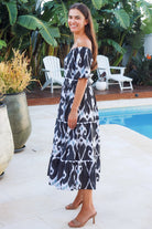 Black ikat boho midi dress worn on or off shoulder with empire waist cotton lace trim tiers and shirred back panel