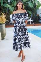 Black ikat boho midi dress worn on or off shoulder with empire waist cotton lace trim tiers and shirred back panel