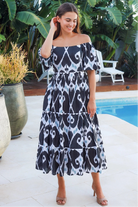 Black ikat boho midi dress worn on or off shoulder with empire waist cotton lace trim tiers and shirred back panel