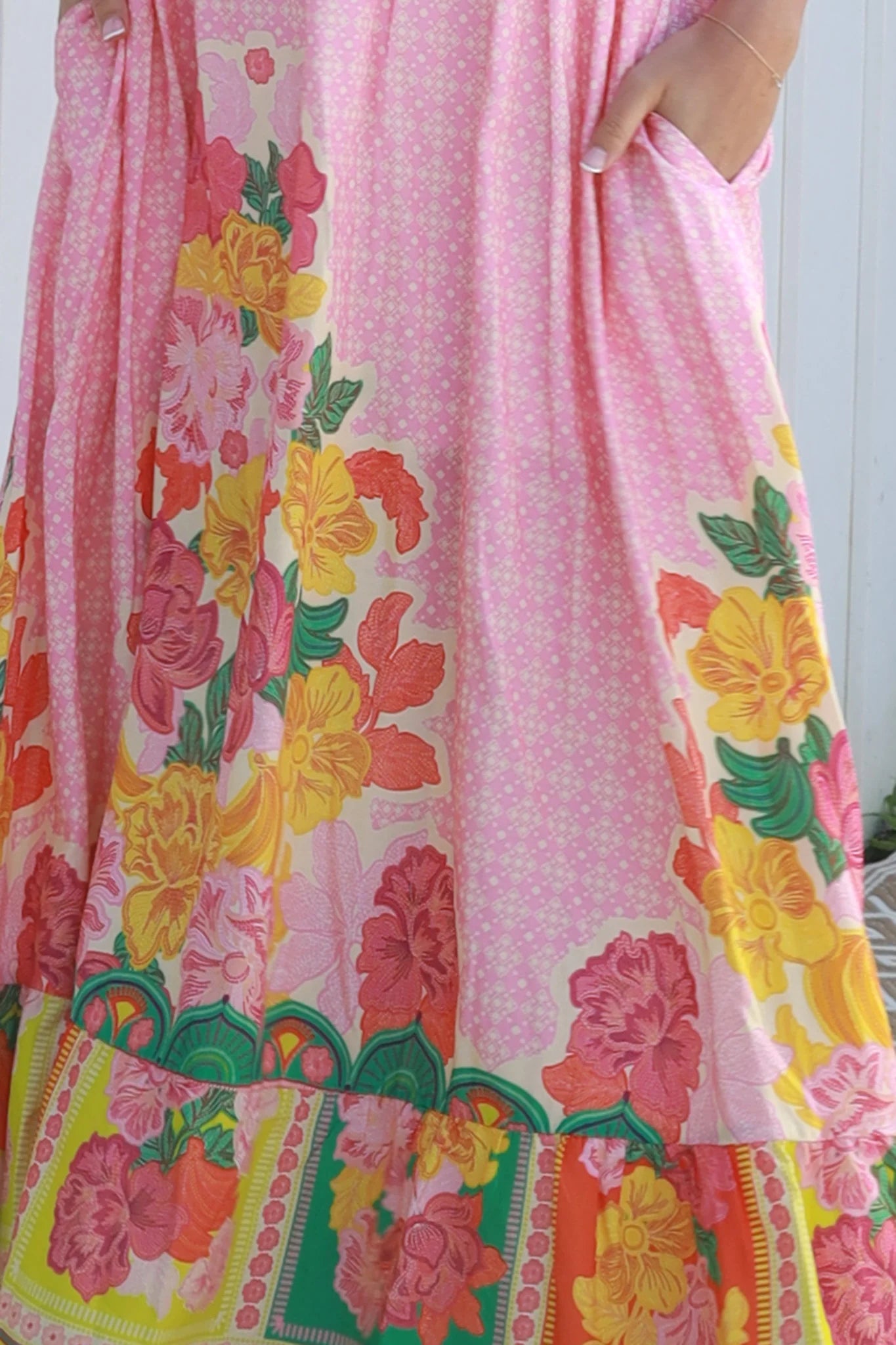 Woman wearing pink floral boho maxi dress with rickrack trim and oversized border hem – Salty Palm