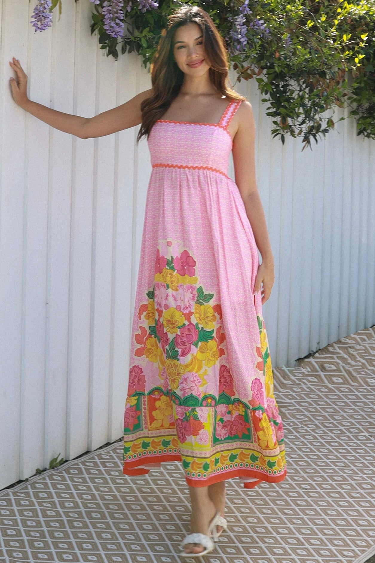 Woman wearing pink floral boho maxi dress with rickrack trim and oversized border hem – Salty Palm