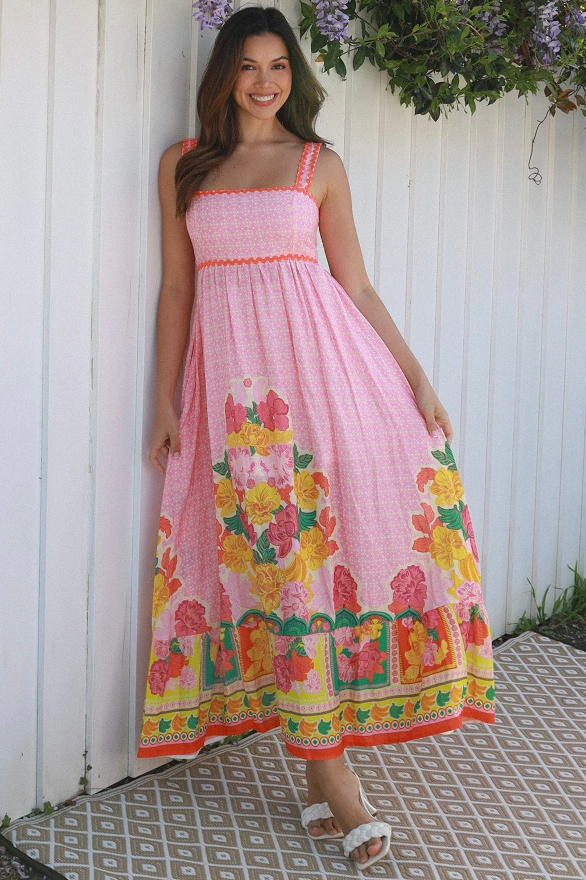 Woman wearing pink floral boho maxi dress with rickrack trim and oversized border hem – Salty Palm