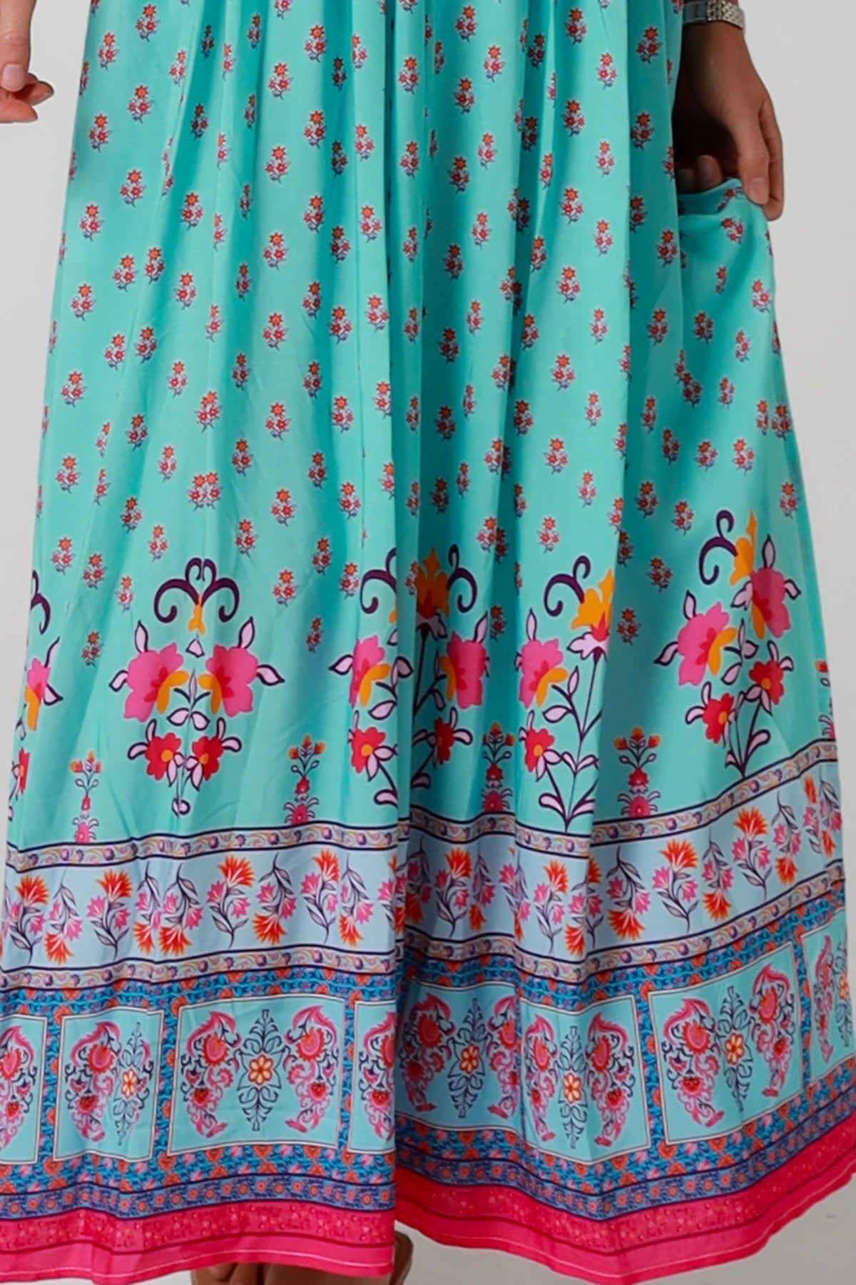 Woman in turquoise floral boho maxi dress with kimono sleeves and border print - Amara Field Maxi Dress Australia.