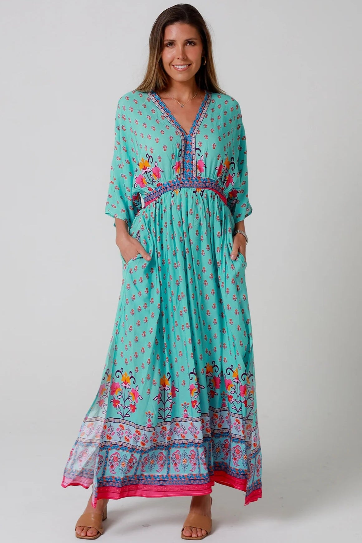 Woman in turquoise floral boho maxi dress with kimono sleeves and border print - Amara Field Maxi Dress Australia.