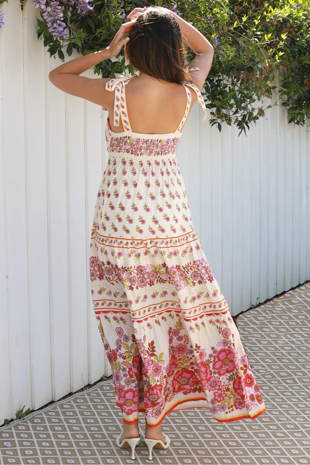 Cream rayon boho maxi dress with blush and rose floral print, tie shoulders, lace trim, and border hemline — Love at First Bloom