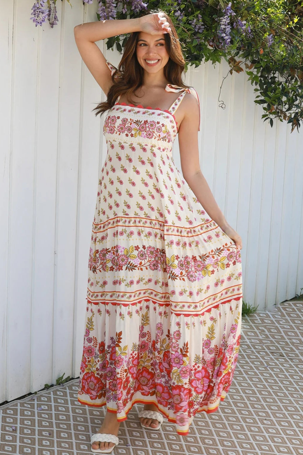 Cream rayon boho maxi dress with blush and rose floral print, tie shoulders, lace trim, and border hemline — Love at First Bloom