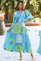 Woman in blue-green patchwork boho midi dress with v-neck and cuffed sleeves – Dreamcatcher Australia