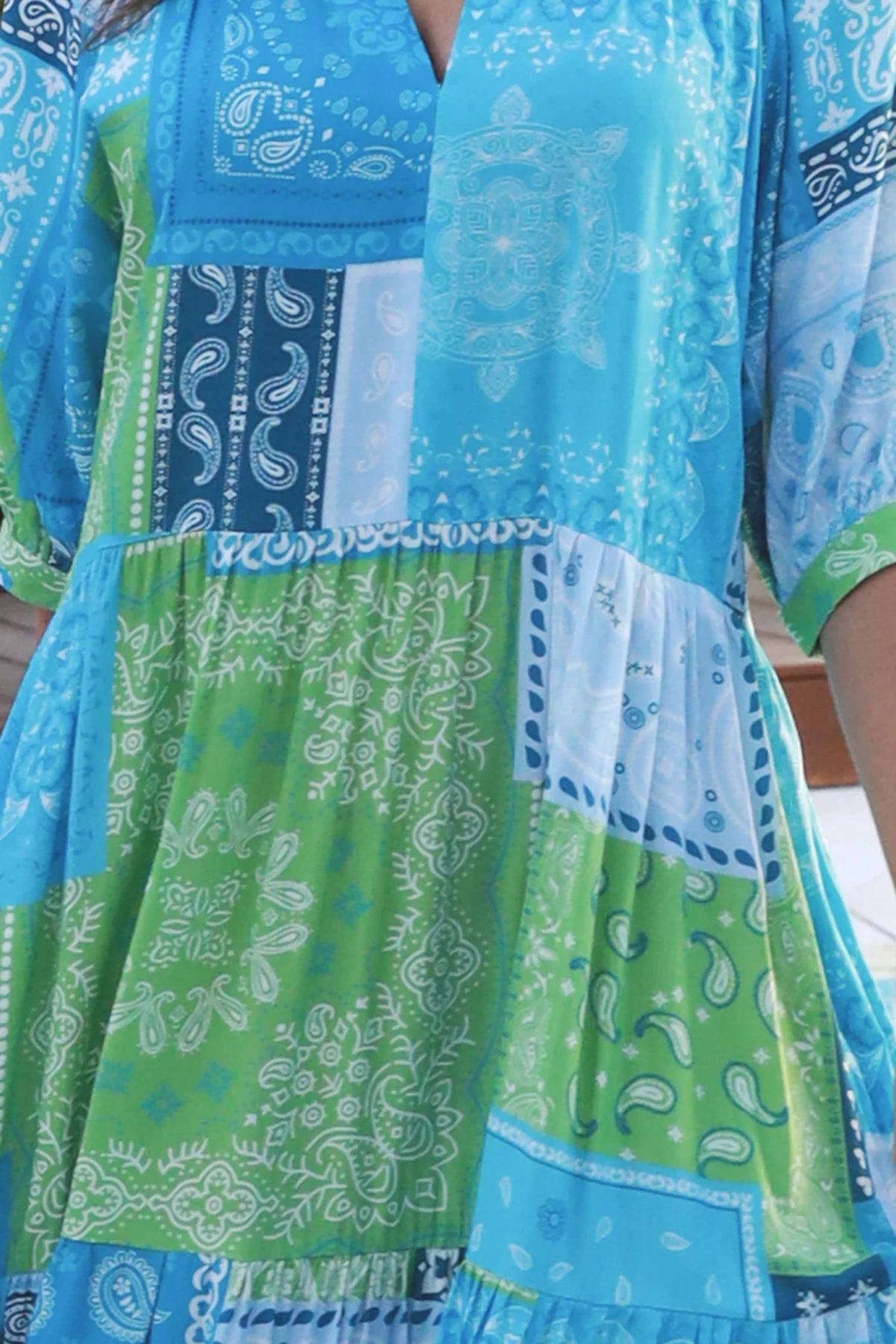 Woman in blue-green patchwork boho midi dress with v-neck and cuffed sleeves – Dreamcatcher Australia