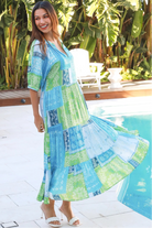 Woman in blue-green patchwork boho midi dress with v-neck and cuffed sleeves – Dreamcatcher Australia