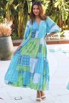 Woman in blue-green patchwork boho midi dress with v-neck and cuffed sleeves – Dreamcatcher Australia
