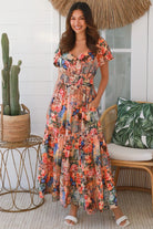 Bohemian maxi dress in butterfly floral print with elastic waist, smocked back, pockets and dramatic tiered hemline