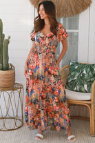 Bohemian maxi dress in butterfly floral print with elastic waist, smocked back, pockets and dramatic tiered hemline