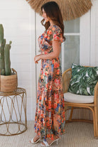 Bohemian maxi dress in butterfly floral print with elastic waist, smocked back, pockets and dramatic tiered hemline
