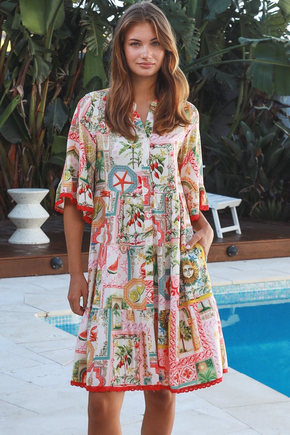 Woman wearing Zimmy tiered mini dress in rayon with button-through front and bohemian print by Salty Palm Australia