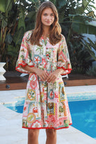 Woman wearing Zimmy tiered mini dress in rayon with button-through front and bohemian print by Salty Palm Australia